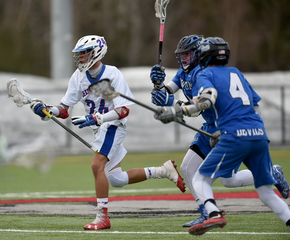 Messalonskee's Dan Gusmanov, left, is chased by the Lewiston defense during a game Thursday at Thomas College in Waterville.