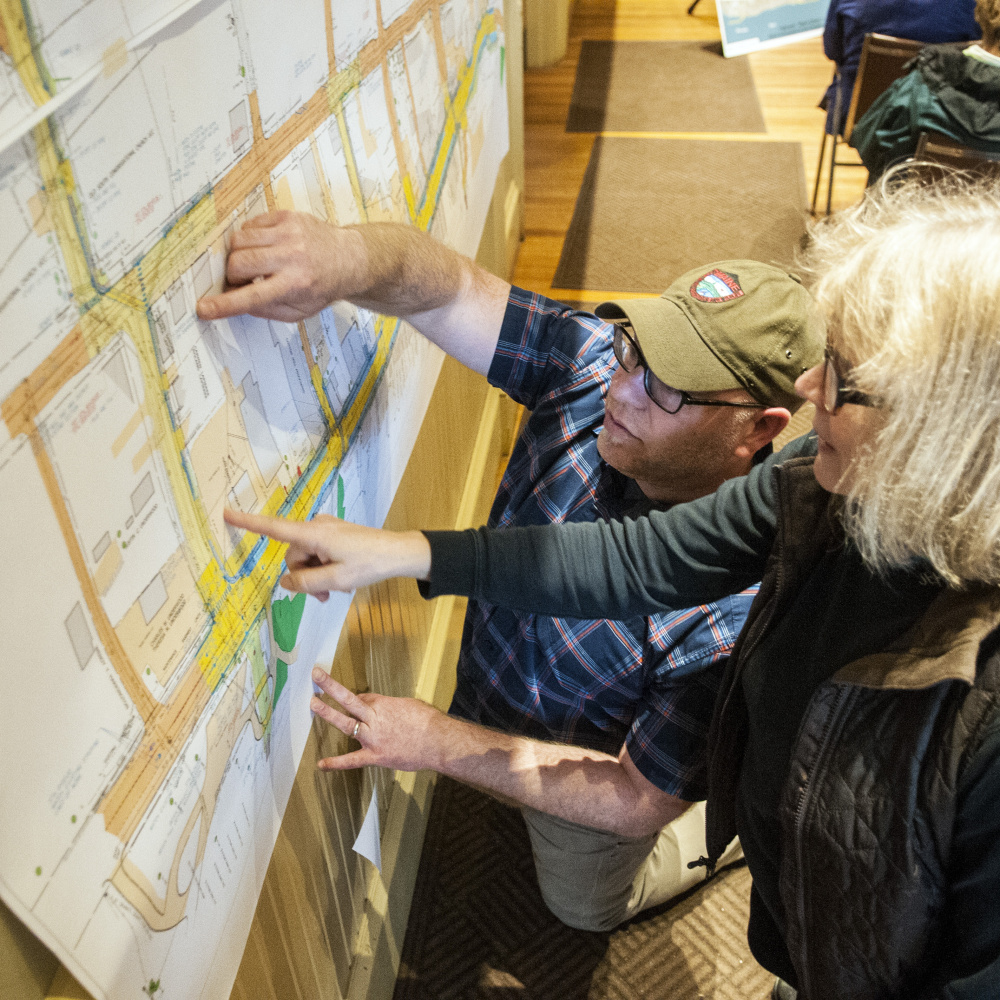 Hallowell Ward 4 Councilor Diano Circo, left, and Andrea Lapointe look at a large map Thursday for details around Temple Street, where Lapointe owns rental property before a meeting about Water Street construction between Maine Department of Transportation officials and Hallowell residents in Hallowell City Hall.