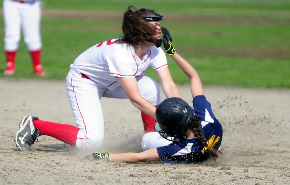 Cony shortstop Carly Lettre, top, tags out Mt. Blue's Samantha Ellis during a game Friday at Newman Brann Memorial Field in Augusta.