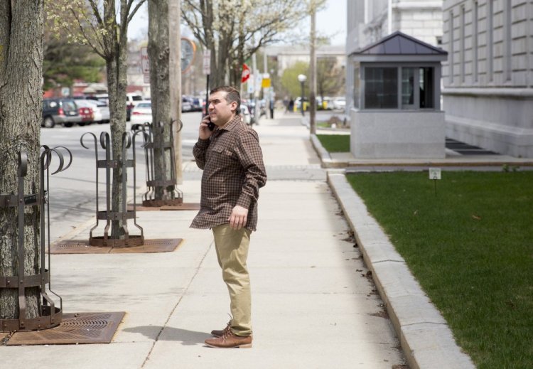 Ali Ratib Daham, 40, talks on the phone outside the federal courthouse in Portland in May. He and his brother Abdulkareem Daham, 21, were charged with perpetrating a scheme to defraud the government of tens of thousands of dollars through their operation of the Ahram Halal Market on Forest Avenue.