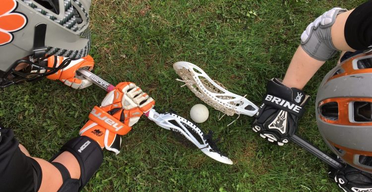 Gardiner Area High School midfielders Garrett Hinkley, left, and Sloan Berthiaume work on faceoffs during lacrosse practice on Tuesday.