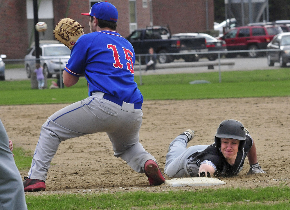 Bridgeway's Jordan Hadley scrambles back to first base as Oak Hill's Reid Cote fields the throw Wednesday in North Anson.