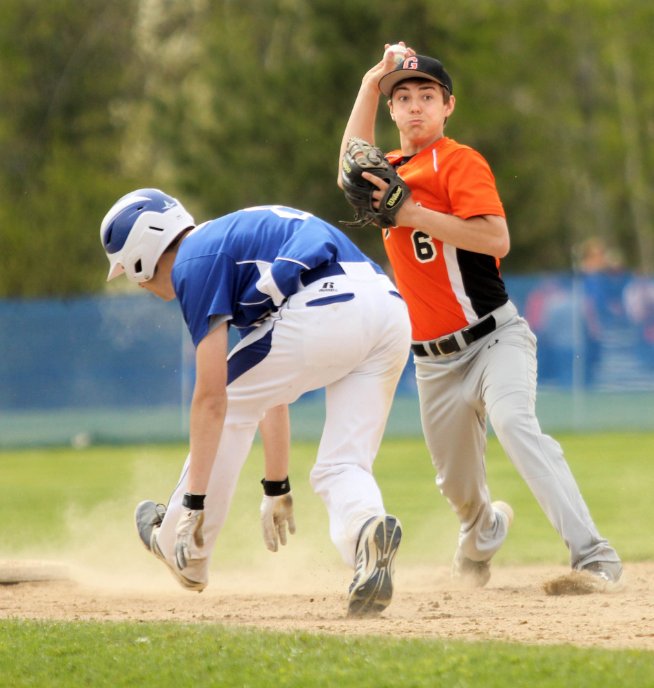 Photo by Jeff Pouland 
 Gardiner Area High School shortstop Devon Maschino turns a double play on Erskine Academy's Cody Taylor, left, and Dylan Presby (not shown) on Saturday in South China.