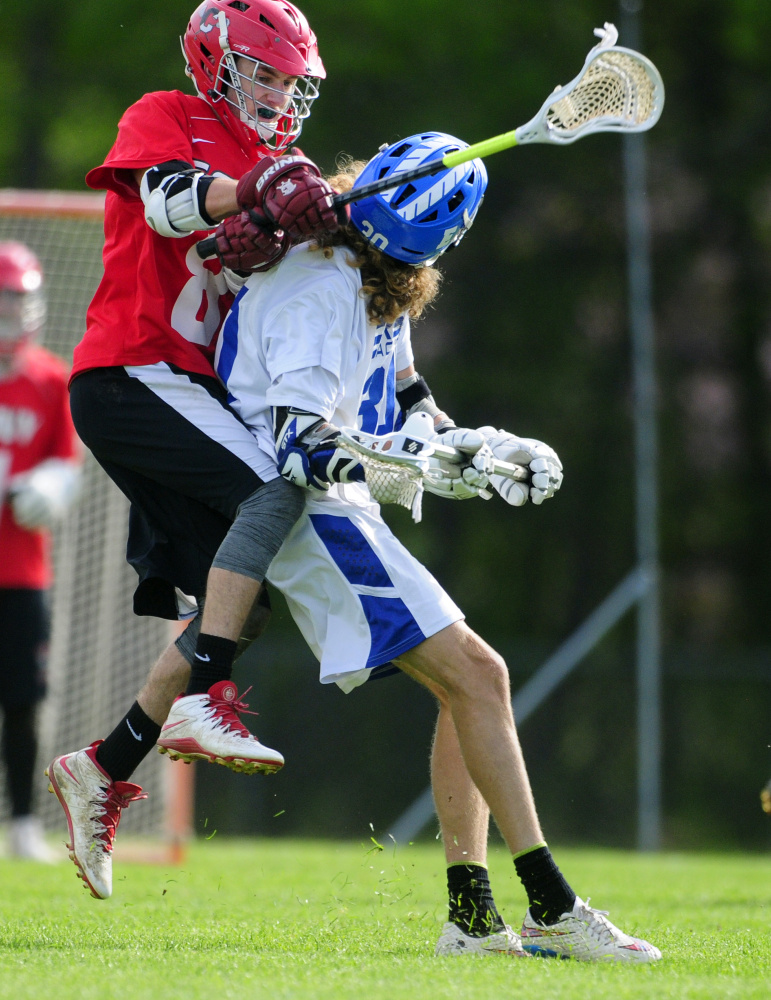 Cony's Cody Lamarre, left, defends Erskine's Grayson Petty during a Kennebec Valley Athletic Conference Class B game Tuesday in South China.