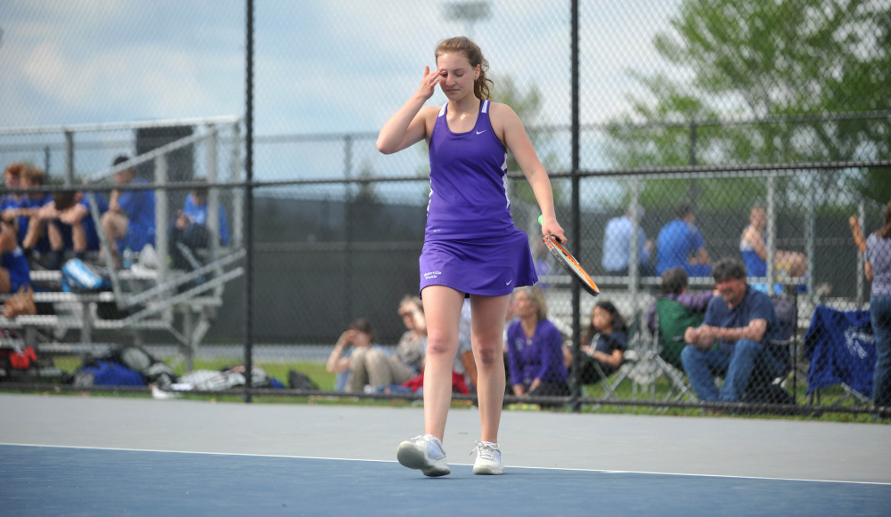 Waterville's Clio Bazakas wipes sweat from her forehead during a match against Erskine's Regina Harmon on Wednesday at Colby College in Waterville.