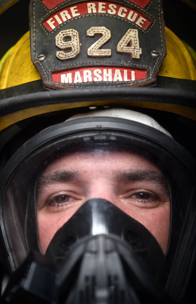 Oakland firefighter Randy Marshall stands wearing the current breathing apparatus that will soon be replaced in Oakland on Saturday.