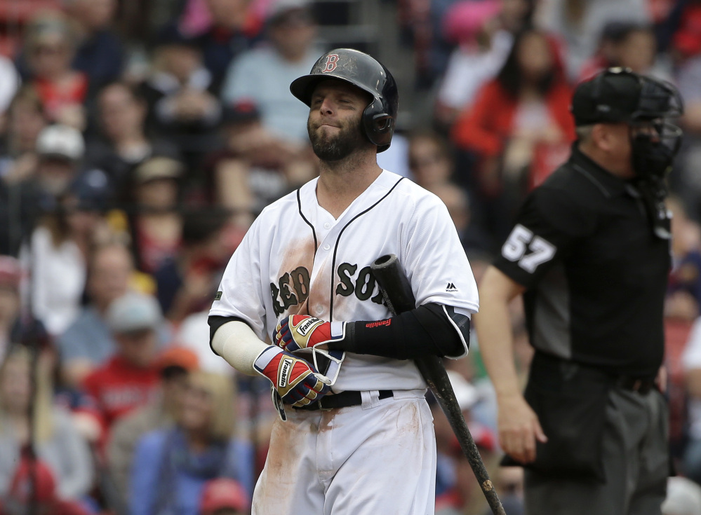 Boston second baseman Dustin Pedroia walks to the dugout after he struck out swinging off a pitch by Seattle's Edwin Diaz in the ninth inning Sunday.