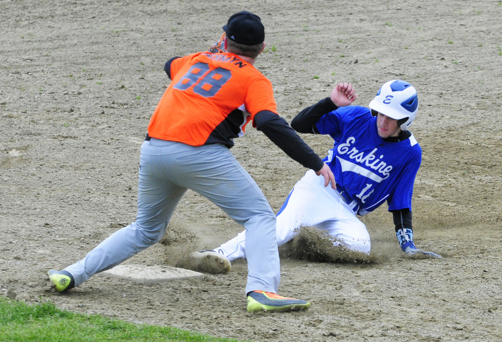 Erskine baserunner Chandler Moore slides safely into third base to beat the throw to Gardiner third baseman Sam Jermyn during a game Tuesday in Gardiner.