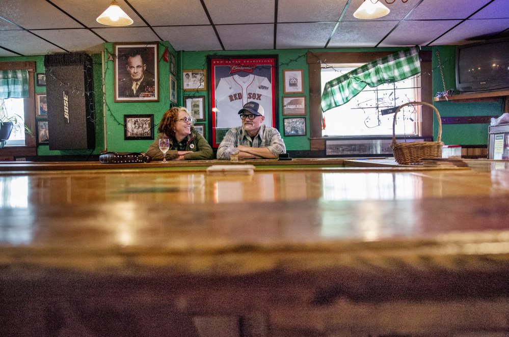 Matthew and Susan Robbins of South Portland talk at the Griffin Club last month. The owner of the business, which closed last week, hopes to reopen elsewhere in the city.