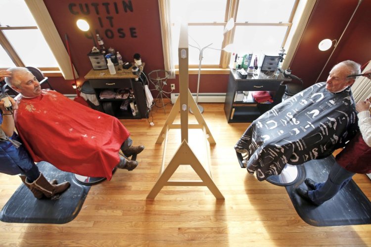 Father and son Alan, right, and Jim Dolloff began getting haircuts together when Jim was just a boy. Since then, they'e never missed getting a trim together. Now, at ages 80 and 52, they continue the tradition at Cuttin' It Close in Standish.