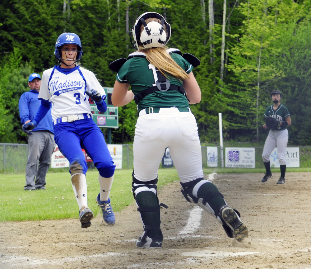 Winthrop catcher Kayleigh Oberg waits with the ball to tag out Madison baserunner Aisha Malloy at home during a game earlier this season in Winthrop.