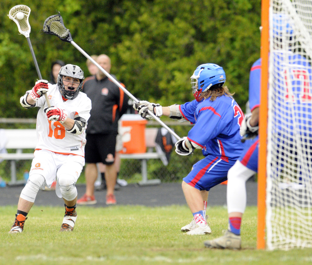 Gardiner's Parker Hinkley takes a shot as Oak Hill's Ethan Richard and keeper Nathan Marcotte play defense during a Class B North semifinal game Friday in Gardiner.