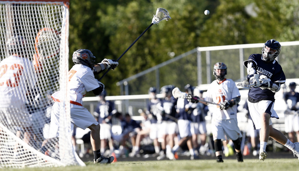 Yarmouth forward Henry Venden shoots and scores on Gardiner in the B North final Wednesday in Gardiner.