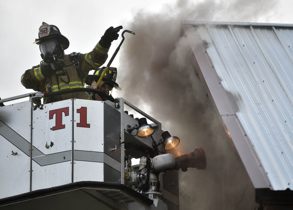 Firefighters from multiple agencies put out an apartment house fire Thursday at 11 High St. in Waterville.