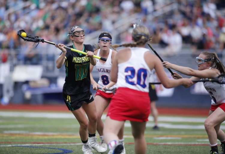 Portland Press Herald photo by Derek Davis 
 Massabesic's Logan Champlin  fires a shot against Messalonskee in the Class A state championship game Saturday at Fitzpatrick Stadium in Portland.