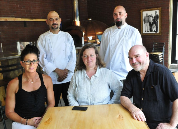 Ready to work at The Miller's Table at Maine Grains in Skowhegan on Tuesday are co-founders Amber Lambke, center, and Jon Kimbell, right, with General Manager Erin Savage, left. Standing are chefs Matthew Crate, left, and Lucas Cates.