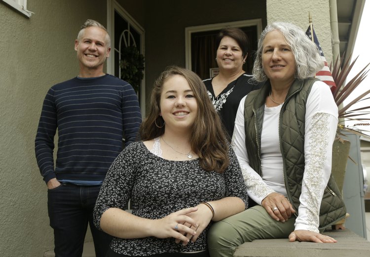 Madison Bonner-Bianchi, center, poses for photos with her parents Mark Shumway, Kimberli Bonner and Victoria Bianchi in Oakland, Calif., on June 8. 