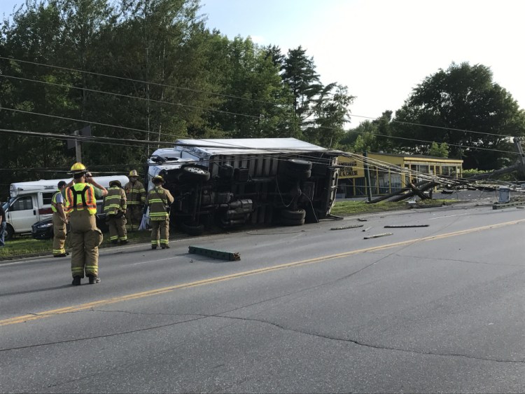 This truck traveling on Tuesday afternoon from Oakland to Waterville flipped over and took out utility poles, a business sign and utility wires to a couple of houses on Kennedy Memorial Drive in Oakland.