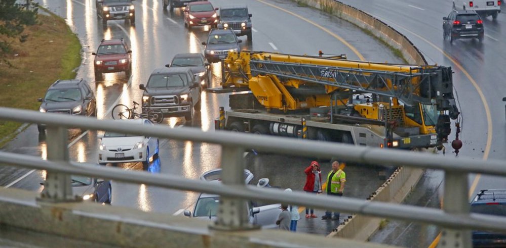 Traffic was slowed in both directions Friday afternoon after a crane crashed in the southbound lane just south of Tukey's Bridge on Interstate 295 in Portland on Friday afternoon. Staff photo by Ben McCanna