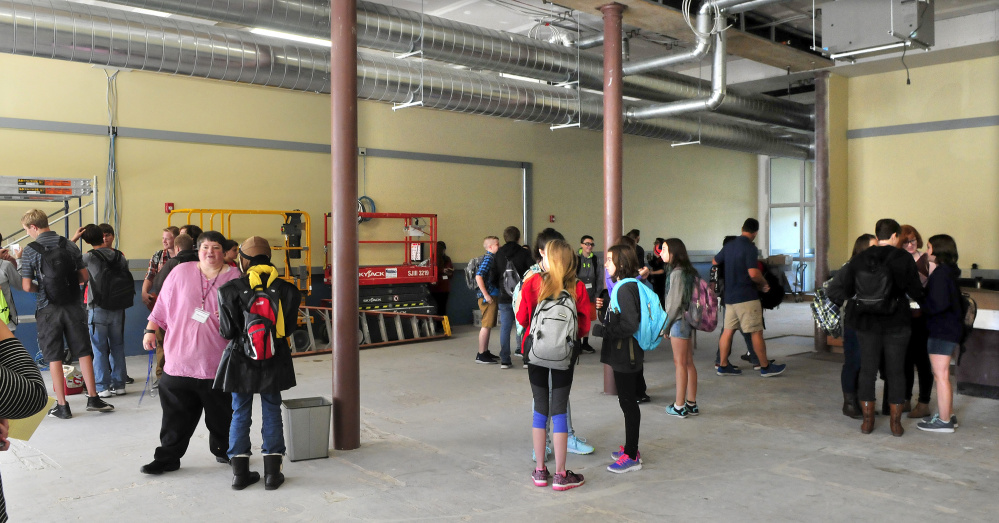 Cornville Regional School Principal Crystal Priest, left, speaks with students inside the as yet unfinished downtown Skowhegan school site on Monday.