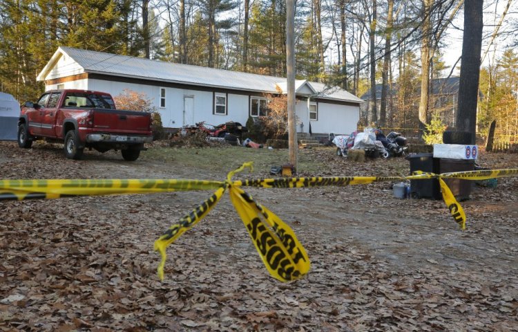 Sheriff's tape cordons off the Songo School Road house in Naples, where police shot and killed Norman J. Strobel Jr., who they say earlier wounded Jason Almeida at a home in Casco. Authorities believe Strobel also shot and killed his roommate in Naples, Richard Diekema.