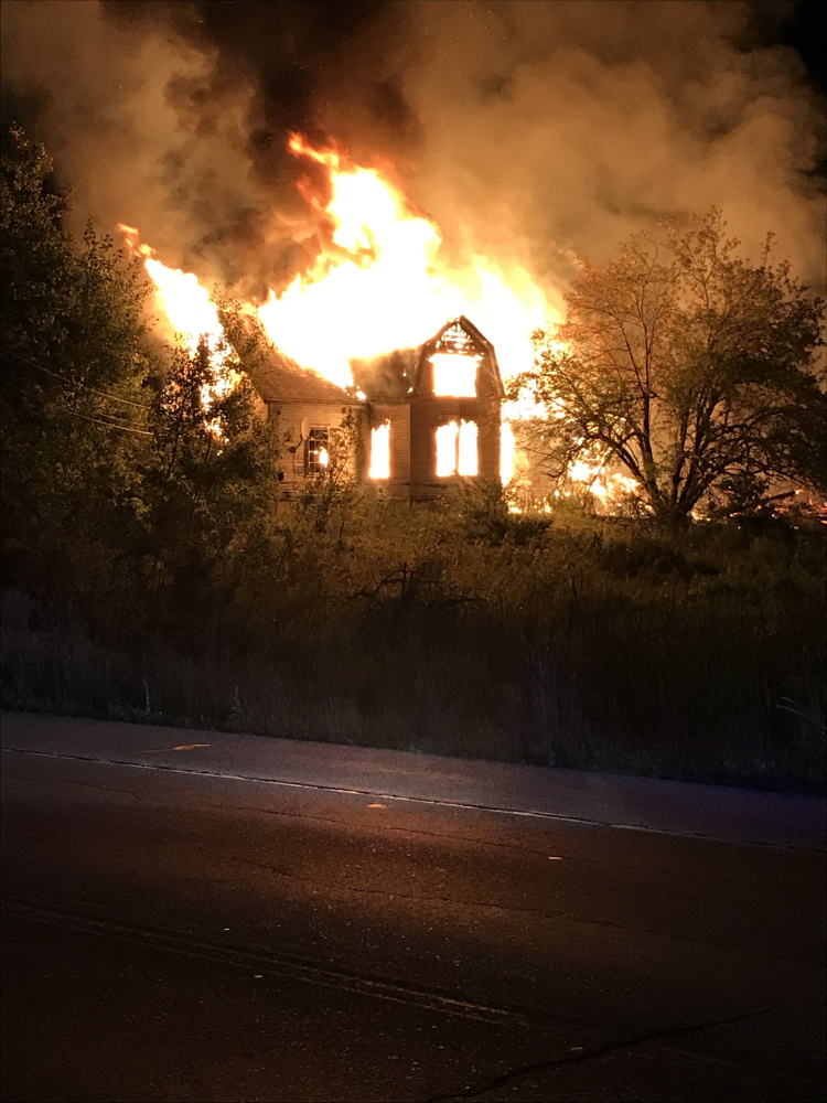 An abanoned building with a barn on North Belfast Avenue in Augusta collapses Friday after fire consumes it. The Chelsea, Togus, Vassalboro and Winthrop fire departments assisted Augusta firefighters at the scene.