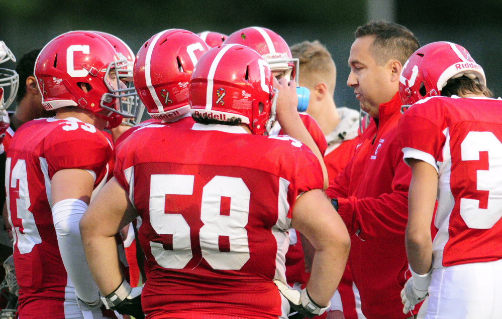 Cony head coach B.L. Lippert talks to the Rams during timeout against Falmouth in a Class B game Friday at Alumni Field in Augusta.