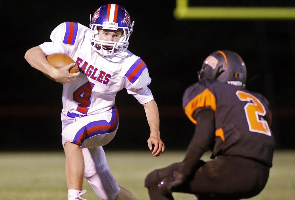 Messalonskee quarterback Deklan Thurston tries to out-maneuver Brunswick defensive back Dalton Dickey during a Pine Tree Conference B game Friday in Brunswick.