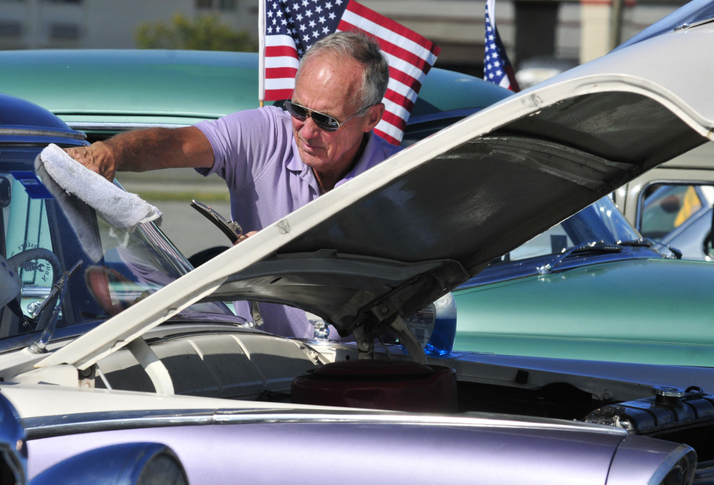 John Kirby, of New Gloucester, polishes the windshield on his 1955 Ford Fairlane on Saturday during a Hurricane Harvey fundraising car show at the Augusta Civic Center.