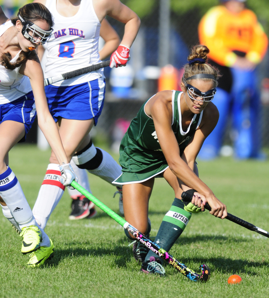 Oak Hill's Lexi Faucher, left, tries to block a shot by Winthrop's Kinli DiBiase during a game Monday in Litchfield.