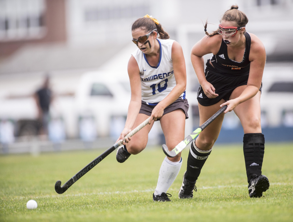 Lawrence High School's Macie Larouche (10) drives down the field as she is defended by Winslow High School's Natalie Greene (2) in Fairfield on Saturday.