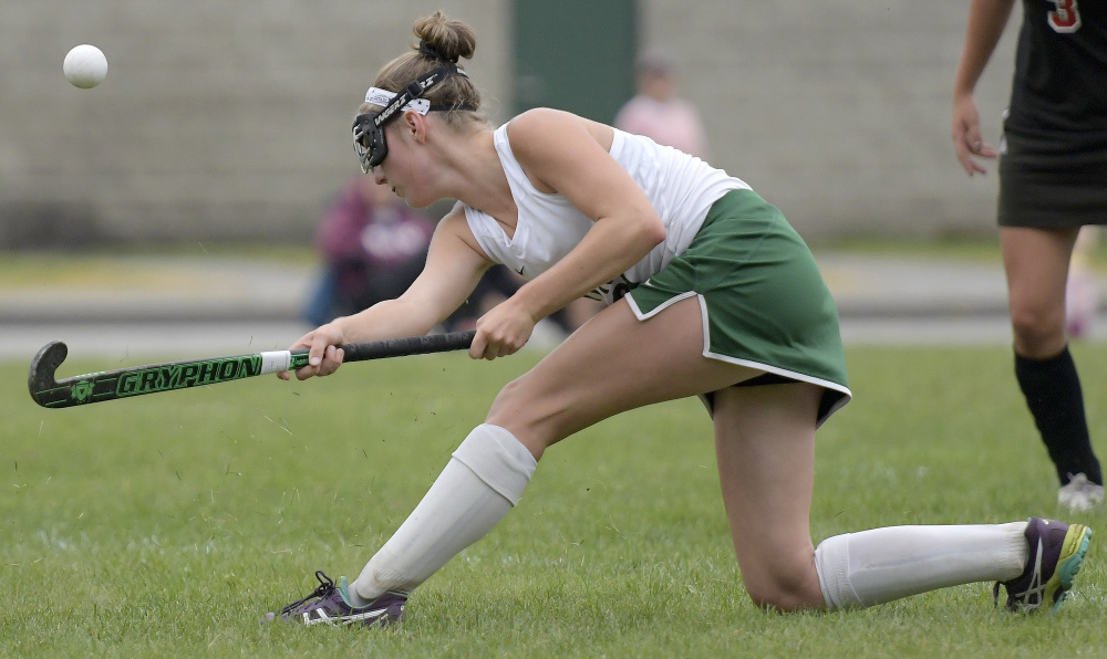 Winthrop's Katie Perkins lifts the ball past Lisbon defenders during a game Monday in Winthrop.