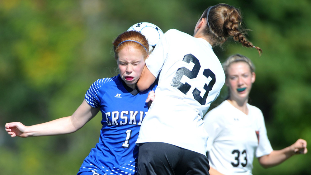 Erskine Academy's Summer Hotham (1) collides with Winslow High School's Meaghan Bernard (23) right, on Saturday at Kennebec Savings Bank Field in Winslow.