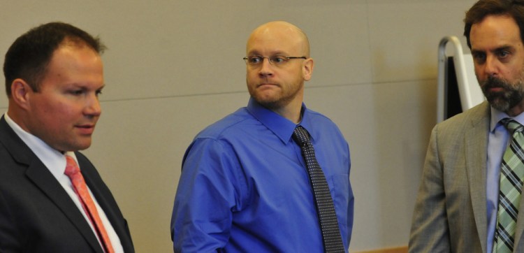 Defendant Robert Burton, center, is flanked by his defense attorneys, Zachary Brandmeir, left, and Hunter Tzovarras, during the first day of his trial Monday in Bangor. Burton is accused of murder in the shooting death of Stephanie Gebo.