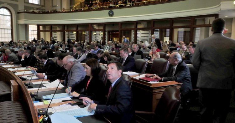 Rep. Kenneth Fredette, R-Newport, looks up at the electronic voting board – which was not working properly – during a special session of the Legislature on Monday.