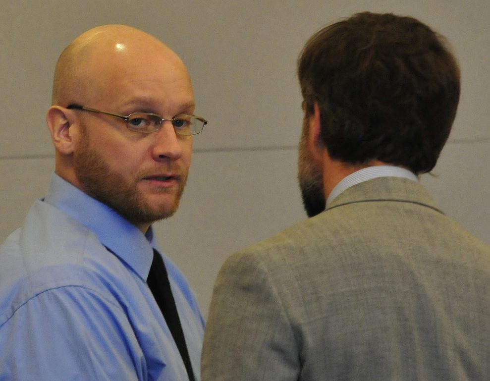 Robert Burton, left, speaks with attorney Hunter Tzorarras during his trial for the murder of Stephanie Gebo at the Penobscot Judicial Center Court in Bangor in October.