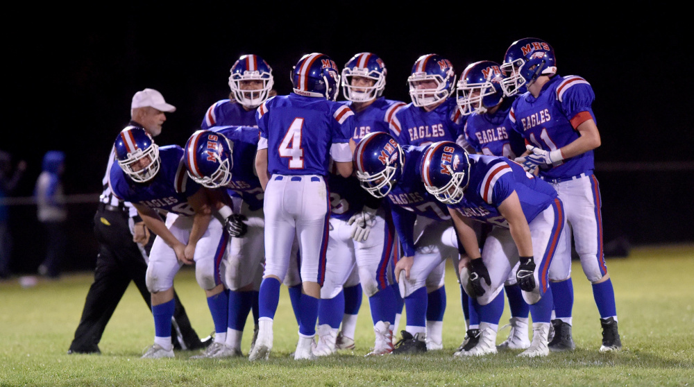 The Messalonskee offense huddles prior to running a play during a Pine Tree Conference Clas B game last Friday in Oakland.