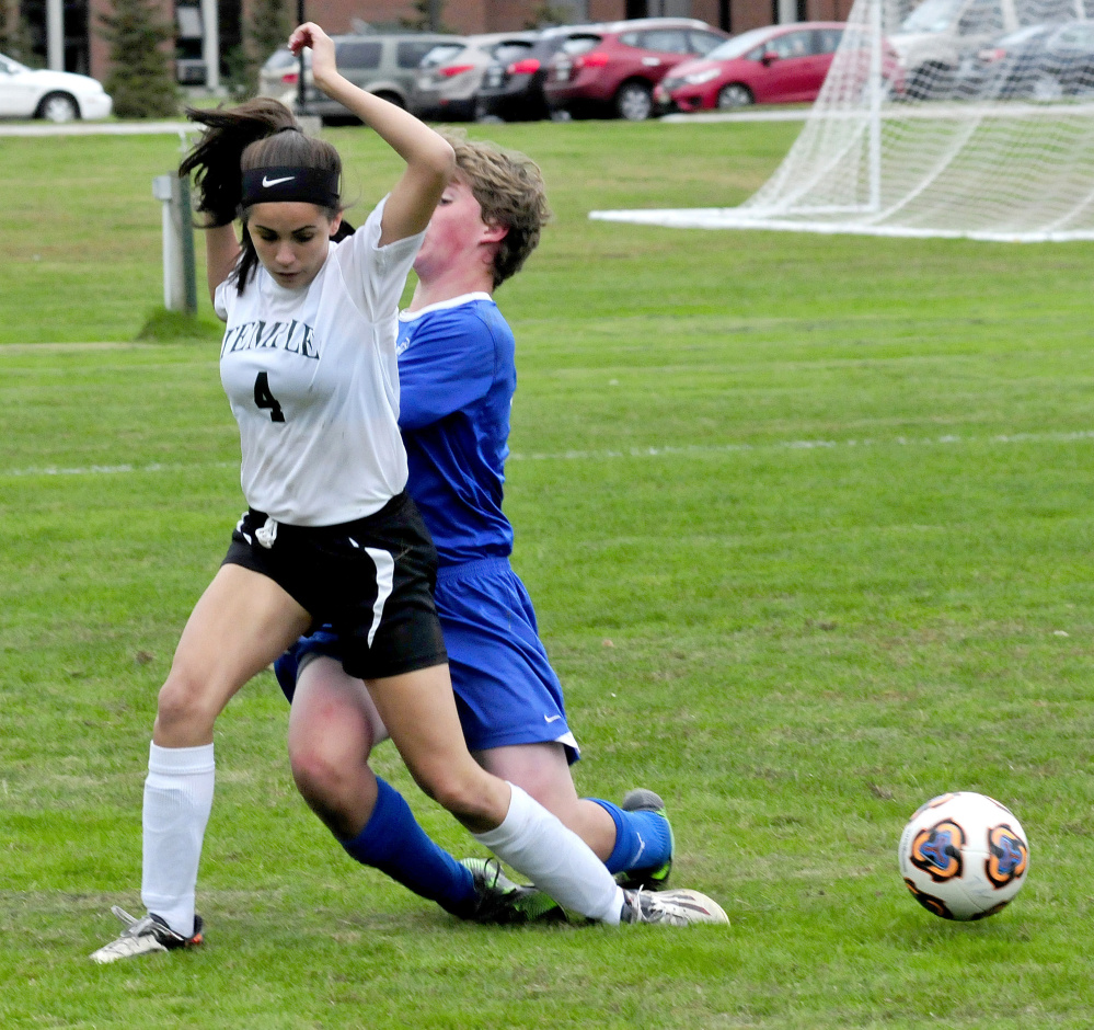 Temple Academy's Delenyi Carr gets hit from behind by Chop Point's Ben Andrus during a game Wednesday in Waterville.