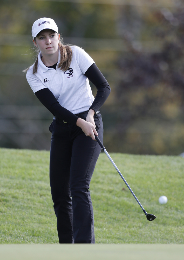 Page Anna Smith of MCI chips on to the green of the 18th hole during the state individual golf championships Saturday at Natnis Golf Course.