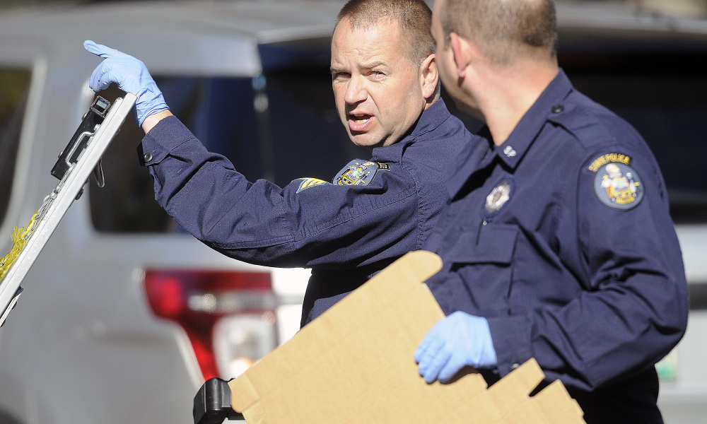 State Police Detective Sgt. Scott Bryant, left, confers November 1, 2016 with Detective Larry Rose while collecting evidence at the Balcer residence in Winthrop following the double murder.