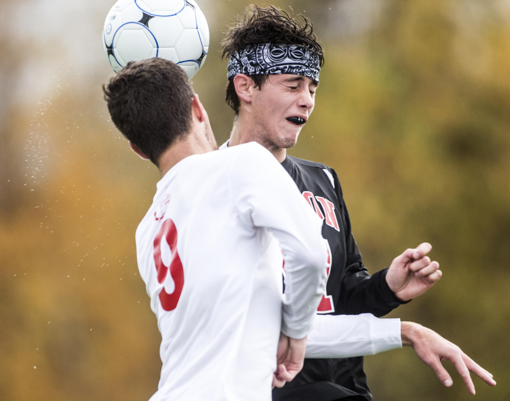  Hall-Dale's Alec Byron (9) collides with Lisbon's Dylan George as they battle for the header in a Class C South quarterfinal game Thursday at Thomas College in Waterville.