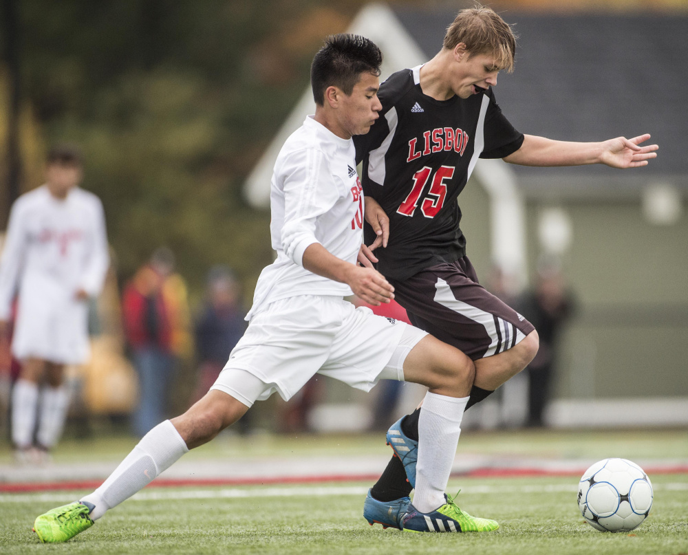 Hall-Dale's Akira Warren, left, battles for the ball with Lisbon's Jacob George in a Class C South quarterfinal game Thursday at Thomas College in Waterville.