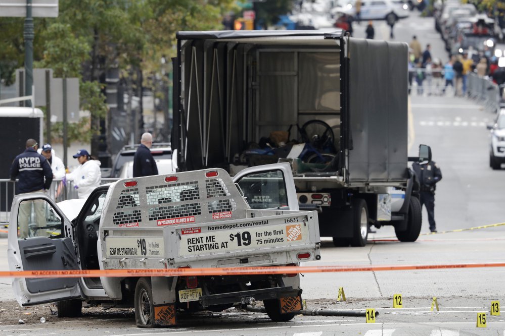 A damaged Home Depot truck remains on the scene Wednesday after the driver mowed down people on a riverfront bike path near the World Trade Center memorial on Tuesday in New York.