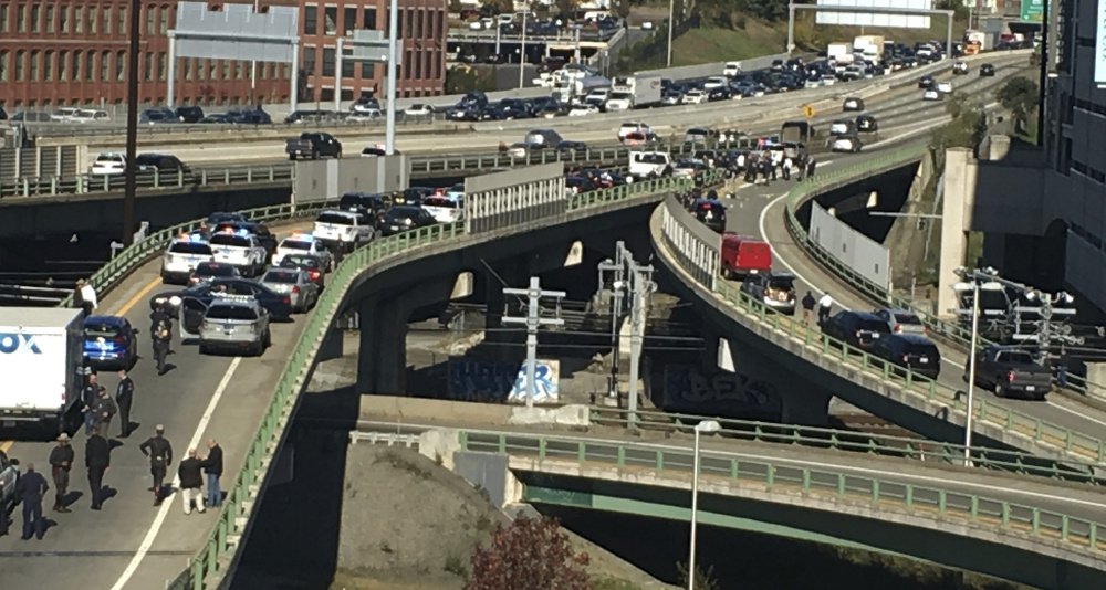 Police congregate on a highway near the Providence Place Mall amid reports of a shooting. Thursday, Nov. 9, 2017, in Providence, R.I. (Lisa Newby/Providence Journal via AP)