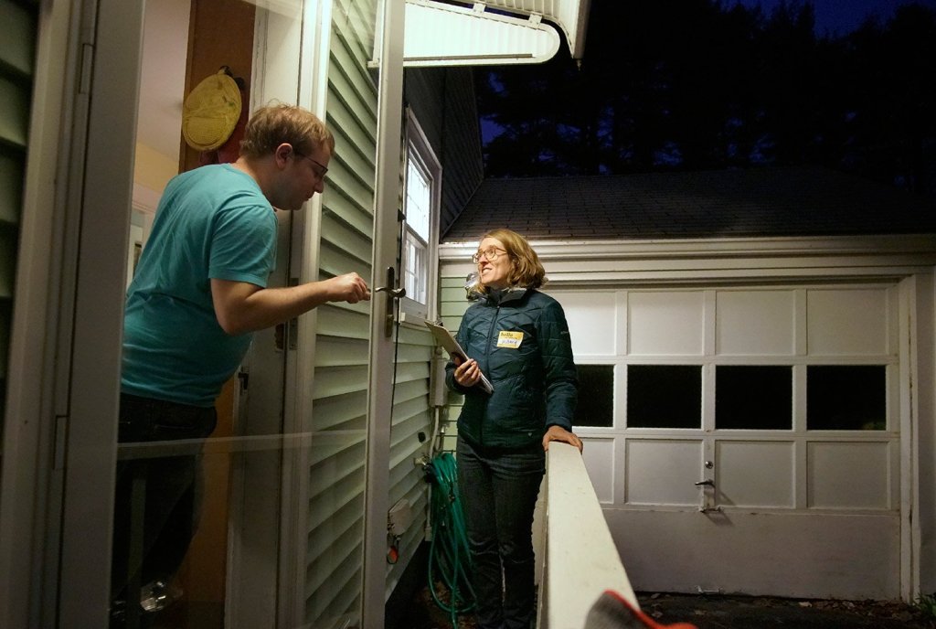 Hillary Barter, a volunteer with Mainers for Health Care, talks with a Westbrook resident Tuesday evening while canvassing for votes for the Medicaid expansion referendum on the statewide ballot.