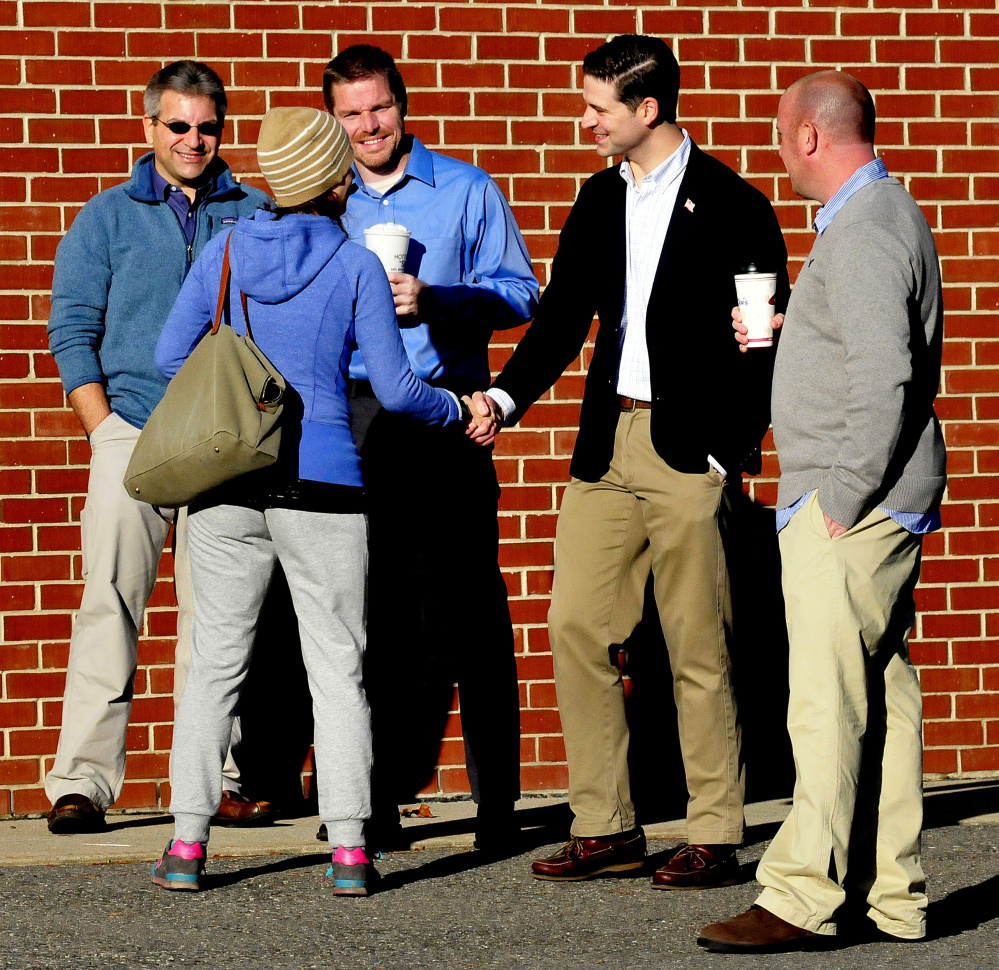 Waterville mayoral candidates, from left, John Levesque, Erik Thomas and Nick Isgro and Ward 4 City Council candidate Chris Rancourt greet Waterville voters Tuesday at the Thomas College polling place.