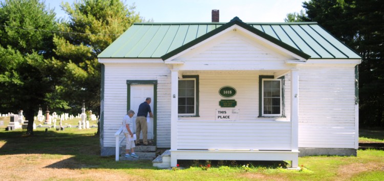 Sandra Lewis, left, and Belgrade Town Manager Dennis Keschl open the front door on Aug. 3, 2016 during a tour of the Belgrade town house. Voters approved allowing the historical society to spend money for renovations.