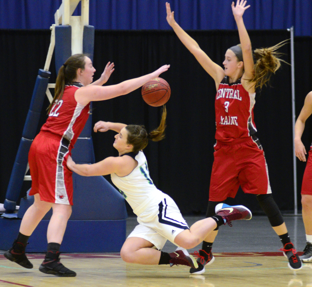 Central Maine Community College defenders Rylee Moore, left, and Alex Bessey flank University of Maine at Augusta's Catherine Sanborn, a Wayne native, during a game Wednesday at the Augusta Civic Center.