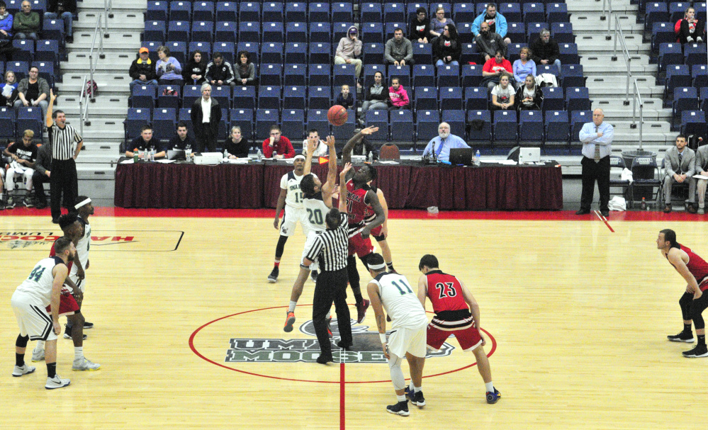 University of Maine at Augusta's Justin Simpson-Bragg, of Fairfield, left, and Central Maine Community College's Josh Cherry tip off to start a game on Wednesday at the Augusta Civic Center.