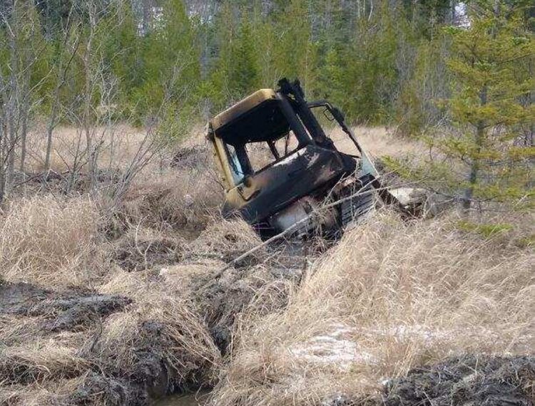 This bulldozer, owned by Cousineau Inc. in Wilton and taken for a joyride, was found by hunters on Tuesday off Beech Hill Road in Sandy River Plantation, where it had been set on fire.